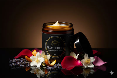 The open jar surrounded by rose petals, jasmine, lavender, and orange peel