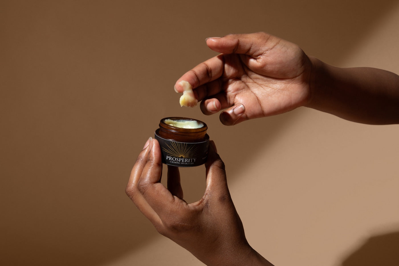A fingertip scoop of Prosperity Butter™ from the 1oz jar